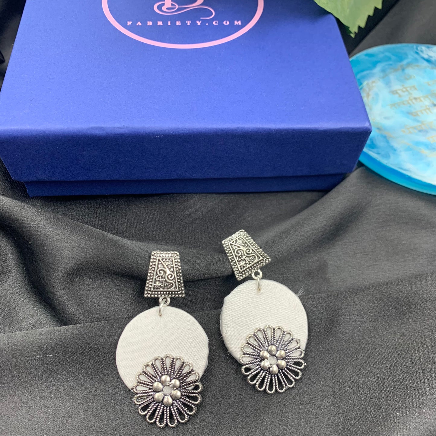 White Fabric Circular Earrings With Silver Charms